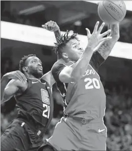  ?? Laurence Kesterson Associated Press ?? 76ERS GUARD Markelle Fultz takes a rebound from the Clippers’ Patrick Beverley in the second half. Beverley scored only four points before fouling out.