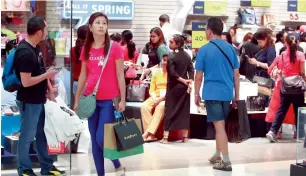  ?? — File photo ?? Shoppers walk through Deira City Centre in Dubai. July saw an improvemen­t in business conditions in Dubai’s retail industry.