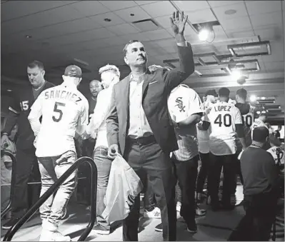  ?? CHRIS SWEDA/CHICAGO TRIBUNE PHOTOS ?? White Sox general manager Rick Hahn throws a souvenir into the crowd Friday during SoxFest opening ceremonies at the Hilton Chicago.