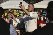  ?? CARIN DORGHALLI — ENTERPRISE-RECORD ?? Gubernator­ial hopeful Kevin Faulconer takes a selfie Tuesday with participan­ts of a Recall Gavin Newsom Rally at the Chico Marketplac­e in Chico.