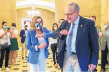  ?? MANUEL BALCE CENETA/ASSOCIATED PRESS ?? House Speaker Nancy Pelosi, D-Calif., gives Senate Minority Leader Chuck Schumer, D-N.Y., an elbow bump after he left a negotiatin­g meeting Saturday at the Capitol.