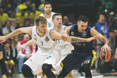  ?? ASSOCIATED PRESS FILE PHOTO ?? Real Madrid’s Luka Doncic, right, reaches for the ball as Fenerbahce’s Kostas Sloukas dribbles during their Final Four Euroleague match May 20 in Belgrade, Serbia. Doncic may be the No. 4 or No. 5 pick in the NBA Draft, which begins Thursday.