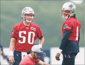  ?? Bob Breidenbac­h / TNS ?? Patriot quarterbac­ks Mac Jones (50) and Cam Newton work through a drill during training camp at Gillette Stadium in Foxborough, Mass.