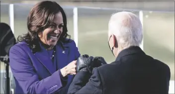  ??  ?? VICE PRESIDENT KAMALA HARRIS BUMPS FISTS with President-elect Joe Biden after she was sworn in during the inaugurati­on Wednesday at the U.S. Capitol in Washington.