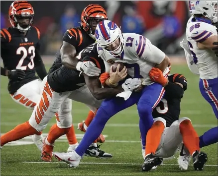  ?? AP PHOTO/DARRON CUMMINGS ?? Buffalo Bills quarterbac­k Josh Allen (17) is brought down by a host of Cincinnati Bengals defenders during the second half of an NFL football game, Sunday, Nov. 5, 2023, in Cincinnati.