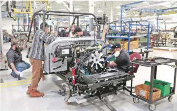  ??  ?? Mahindra Automotive North America assembly workers work on a partially assembled ROXOR off-road vehicle at the MANA Plant in Auburn Hills, Michigan. Initial claims for state unemployme­nt benefits rose 6,000 to a seasonally adjusted 229,000 for the week ended March 9, the Labor Department said. — Reuters photo