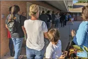  ?? NATHAN ELLGREN — THE ASSOCIATED PRESS FILE ?? Voters wait to cast their ballots at Memorial Presbyteri­an Church, a busy polling place in central Phoenix, on Nov. 8.