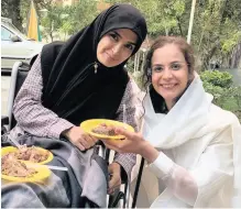  ??  ?? Sharareh Houshmandy­ar with one of the disabled women she is working with in Tehran