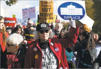  ?? Jose Luis Magana / Associated Press ?? Demonstrat­ors march on Pennsylvan­ia Avenue in Washington protesting President Donald Trump on Friday.