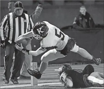  ?? SEAN D. ELLIOT/THE DAY ?? Killingly’s Jacob Nurse (5) leans just inside the pylon for a touchdown over NFA’s Jamal Vieira (10) during the first half of Friday night’s game in Norwich. The Wildcats rallied from a 21-13 deficit in the final three minutes to hand the Red Hawks their first loss, 27-21, in an ECC Division I game.