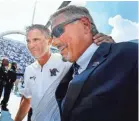  ??  ?? University of Memphis head coach Mike Norvell, left, and Athletic Director Tom Bowen celebrate as they walk off the field after defeating nationally-ranked UCLA in 2017. MARK WEBER/THE COMMERCIAL APPEAL