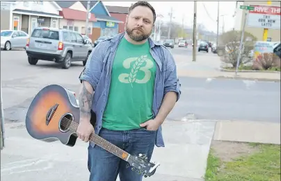  ?? SHARON MONTGOMERY-DUPE/CAPE BRETON POST ?? Rob Murphy of New Waterford stands on Plummer Avenue with his guitar. Murphy, a singer/songwriter, was so shocked about the 354-day wait time for mental health assistance in the CBRM he wrote a song ‘300 Days’ a few months ago that is now being...