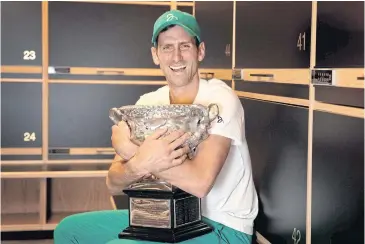  ?? AFP ?? Novak Djokovic poses with the trophy after winning the Australian Open in Melbourne last year.