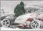  ?? GENE WALSH — DIGITAL FIRST MEDIA ?? A motorist cleans snow off a vehicle along Ridge Pike in Lower Providence on Friday.