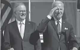  ?? BRENDAN SMIALOWSKI/POOL/AFP VIA GETTY IMAGES ?? Australian Prime Minister Anthony Albanese joins President Joe Biden in a welcoming ceremony at the White House Tuesday.