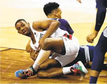  ?? K.C. ALFRED U-T ?? SDSU guard Lamont Butler makes one of the Aztecs’ hustle plays that helped his team win the title.