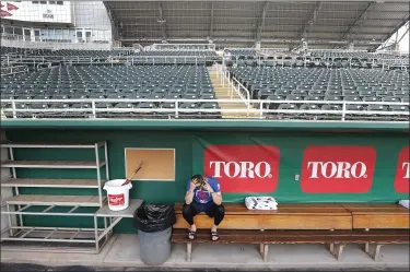  ?? ELISE AMENDOLA — THE ASSOCIATED PRESS ?? Twins catcher Mitch Garver talks on his phone in an empty Hammond Stadium on March 12in Fort Myers, Fla.