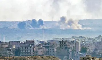  ?? — AFP ?? A general view taken from the government-held side of Aleppo shows smoke billowing from the Sheikh Said district.