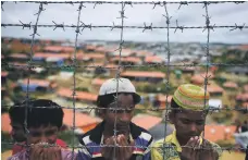  ??  ?? Rohingya refugees pray at a ceremony in the Kutupalong camp in Ukhia, Bangladesh, last month AFP