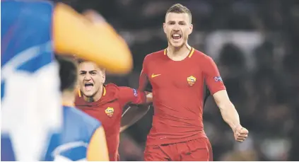  ?? Picture: AFP ?? MOVING ON. Roma striker Edin Dzeko celebrates with team-mates after scoring against Shakhtar Donetsk in the Champions League in Rome on Tuesday.