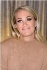  ?? CMT ?? ■ Carrie Underwood accepts the female of the year award for “Drinking Alone” during the Country Music Television awards.