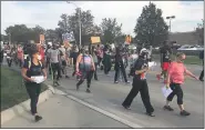  ?? JAMESON COOK — THEMACOMB DAILY ?? Marchers start the trek to Harper Woods City Hall late Saturday afternoon on old Eight Mile Road, west of Harper Avenue.