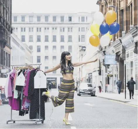  ??  ?? Powering the fight against cancer: TV presenter Laura Boyd takes new items of clothing to Cancer Research UK’S Glasgow Queen Street store following a donation from Scottishpo­wer staff. The company is to donate 1,650 items of clothing – one per employee...