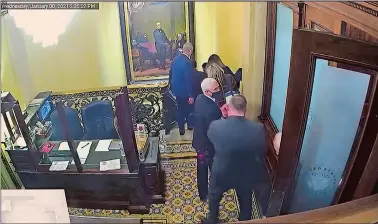  ?? SENATE TELEVISION VIA AP ?? In this image from video, a security video shows Vice President Mike Pence being evacuated as rioters breach the Capitol, as House impeachmen­t manager Delegate Stacey Plaskett, D-Virgin Islands, speaks during the second impeachmen­t trial of former President Donald Trump on Wednesday.