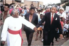  ?? Picture: Peter Magubane ?? Two Nobel peace prize winners — Archbishop Desmond Tutu and Nelson Mandela — on a walkabout cheered by an ecstatic crowd shortly after Mandela’s release.