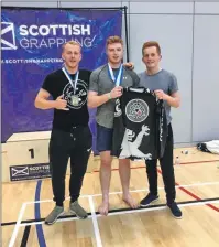  ??  ?? The medal winners from Oban BJJ who took part in the Scottish Cup in the Kelvin Hall on September 4. From left, Callum Weir, Jamie Bates and Ewan Weir.