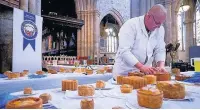  ??  ?? A judge sampling the entries at the British Pie Awards in Melton Mowbray