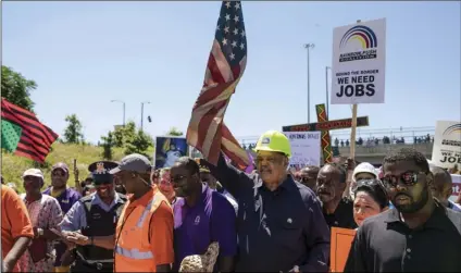  ??  ?? Rev. Jesse Jackson marches alongside Rev. Michael Pfleger leading thousands of protesters into the inbound lanes of Interstate 94 known as the Dan Ryan Expressway Saturday, in Chicago. ASHLEE REZIN /CHICAGO SUN-TIMES VIA AP