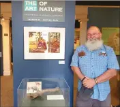  ?? ARIC SLEEPER — SANTA CRUZ SENTINEL ?? Local paleontolo­gist Wayne Thompson stands next to the fossilized arm bone of a Jefferson's ground sloth that was found in the Santa Cruz Mountains by a group of children.