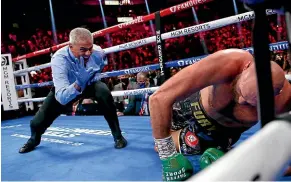  ?? AP ?? Referee Russell Mora counts to Fury after he was knocked down by Wilder in the fourth round of their heavyweigh­t championsh­ip bout.