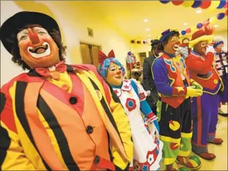  ??  ?? JOSE GONZALEZ, left, from Chicago, enjoys a laugh with fellow profession­als at the sixth annual Internatio­nal Latino Clown Convention in Los Angeles. Being a clown in the U.S. isn’t always easy.
