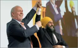 ?? The Canadian Press ?? NDP Leader Jagmeet Singh and Premier John Horgan celebrate during the B.C. NDP Convention at the Victoria Convention Centre in Victoria in 2019.