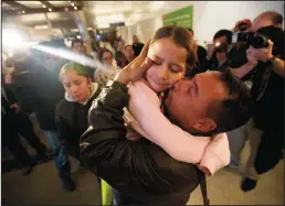  ?? JASON ARMOND/LOS ANGELES TIMES ?? Fernando Arredondo embraces his daughter, Alison Arredondo, at Los Angeles Internatio­nal Airport on Jan. 22. Arredondo was one of 11 parents who were deported without their children during the “zero-tolerance” policy.