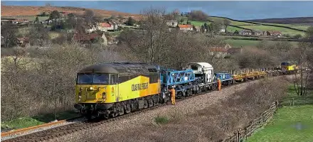  ??  ?? After the first Class 70 pictured at Whitby in last month’s issue, further engineerin­g work on the Esk Valley line brought Colas ‘Grids’ Nos. 56087 and 56094 to the route, seen reforming the Balfour TRT at Danby ready to leave as the 6C80 to Doncaster Decoy Yard on March 1. The work also saw classmates Nos. 56078 and 56096 in use that day. Andrew Mason