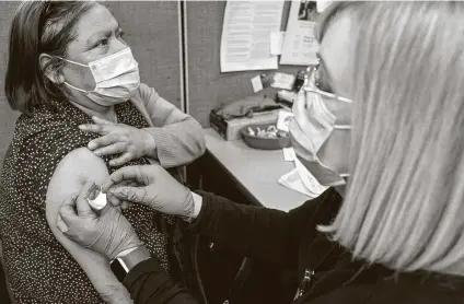  ?? Mary Altaffer / Associated Press ?? Maria Hernandez of Manhattan gets her first dose of the COVID-19 vaccine on Tuesday in New York. On Wednesday, the Biden administra­tion announced it will spend $200 million for the CDC to triple its levels of genetic sequencing to identify mutations.