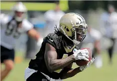  ?? AP Photo/Gerald Herbert ?? ■ New Orleans Saints running back Alvin Kamara carries during training camp Friday at their NFL football training facility in Metairie, La.