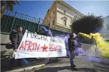  ?? AFP ?? ■ Protesters hold a banner reading ‘Turkey assassin, Afrin resists’ as they demonstrat­e outside the Turkish embassy in central Rome yesterday.