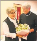  ??  ?? FLORAL: Lion Barbara Fergusson (right) presents Jo Guy with flowers at Dannevirke Host Lions Guest Night.