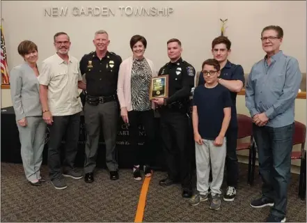  ?? JEN SAMUEL — MEDIANEWS GROUP ?? Police Officer Riley Miller celebrates with his family and Chief Gerald Simpson after receiving the 2021Commis­sioners Award in Landenberg on Thursday.