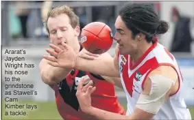  ??  ?? Ararat’s Jayden Wright has his nose to the grindstone as Stawell’s Cam Kimber lays a tackle.