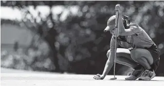  ?? STAFF PHOTO BY C.B. SCHMELTER ?? Cleveland’s Rheagan Hall lines up to putt at the ninth during the District 5 Large high school golf tournament at Cleveland Country Club on Monday. Hall was the girls’ individual winner, and her team won, too.