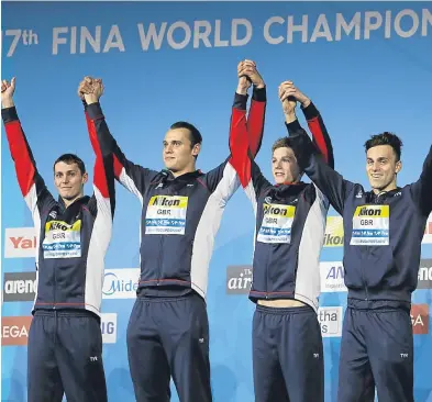  ?? Picture: AP. ?? Stephen Milne, Nicholas Grainger, Duncan Scott and James Guy celebrate on the podium after winning the gold medal in the men’s 4x200m freestyle relay.
