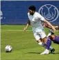  ?? JOHN RAOUX/ ASSOCIATED PRESS ?? Midfielder Marcelino Moreno, who played on the left side Saturday, gets control of the ball against Orlando City.