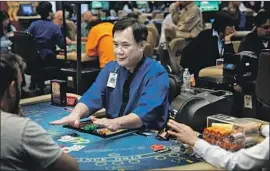  ?? Jay L. Clendenin Los Angeles Times ?? LA NAM deals blackjack at the Gardens Casino in Hawaiian Gardens in 2018. Under new rules, cards could be dealt face up, eliminatin­g the need to touch them.