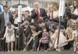  ?? Jabin Botsford/The Washington Post ?? President Donald Trump and first lady Melania Trump blow whistles to begin an Easter Egg Roll race Monday at the White House.