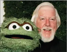  ?? REED SAXON — THE ASSOCIATED PRESS ?? Puppeteer Caroll Spinney, right, who portrays “Sesame Street” characters Oscar the Grouch, left, and Big Bird, arrives for the Daytime Emmy nominee partyon April 27, 2006, at the Hollywood Roosevelt Hotel in Los Angeles.